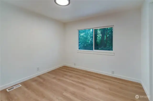 Here is view of good sized 3rd bedroom with views of toward back of home.  This could be second primary bedroom with its own bathroom also for guests