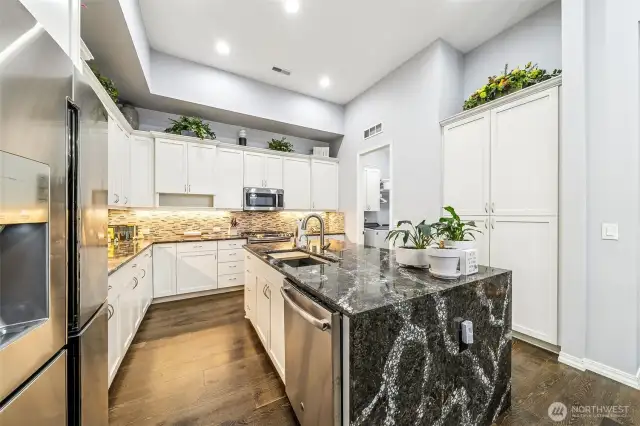 Another view of the kitchen with laundry room in the background