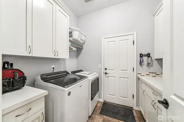 Laundry room between kitchen and garage with even more storage space.