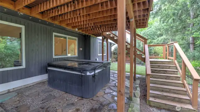 Under deck patio and hot tub is accessible from the lower level rec room or stairs off the deck