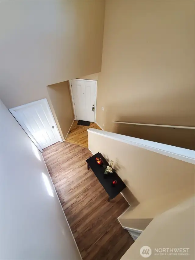 View of the front door/main level entry from atop the stairs.