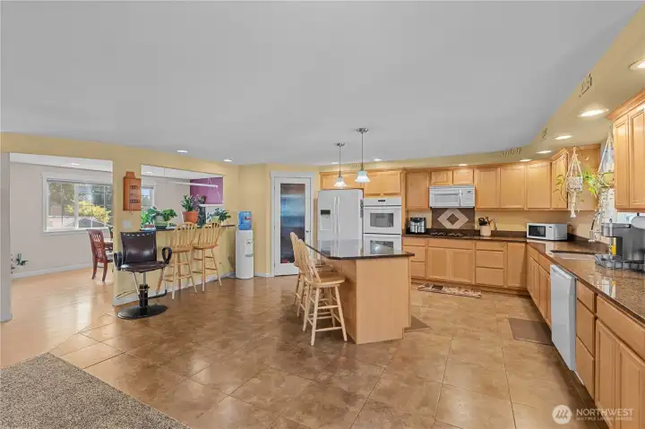 The upper level features the remodeled look of an open concept from the island kitchen with walk-in pantry, to the expansive family room,  to the pass through to the dining room. Entertain your guests with multiple eating areas.