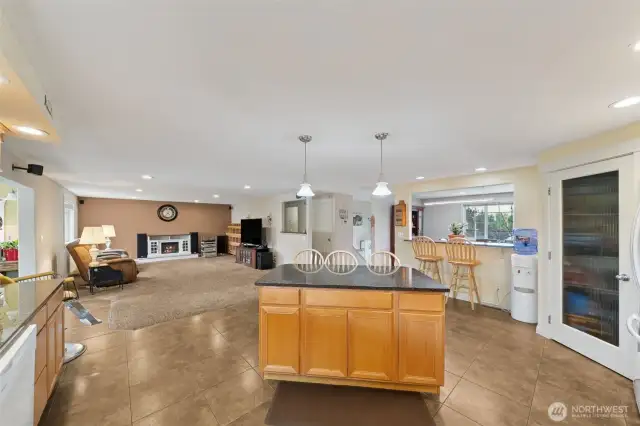 The upper level features the remodeled look of an open concept from the island kitchen with walk-in pantry, to the expansive family room,  to the pass through to the dining room. Entertain your guests with multiple eating areas.