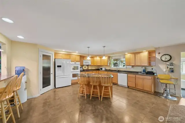 Kitchen on the upper level features an island bar and also a 2nd bar eating area at the pass through to the dining room. There's even space for an additional small table if you desire.