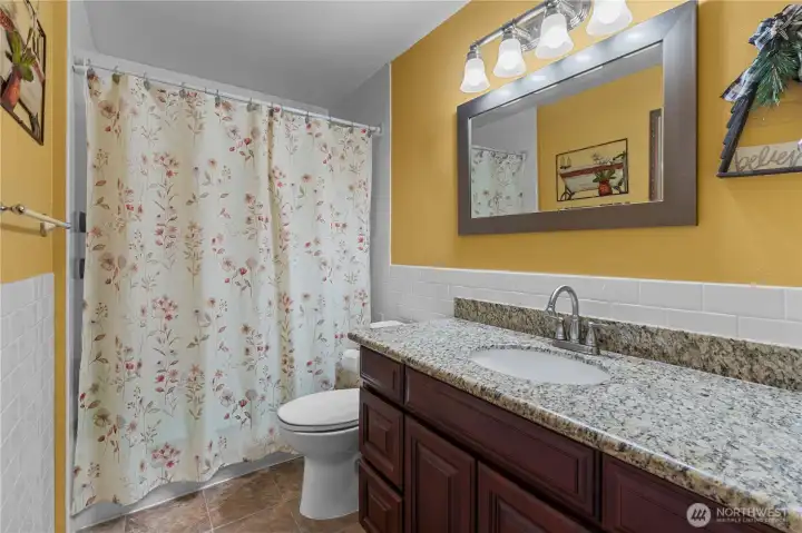 Upper level full bathroom has been remodeled with granite counters and subway tile back splash.