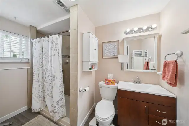 Primary bathroom attached to the main bedroom with a tile shower.