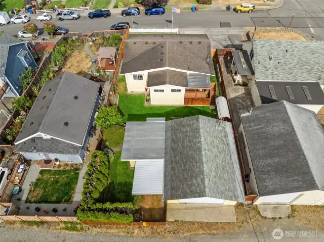 Aerial view of the property. From the alley access the detached garage/shop, covered carport, enjoy the backyard and expanded home. Owner has taken great care of this property!