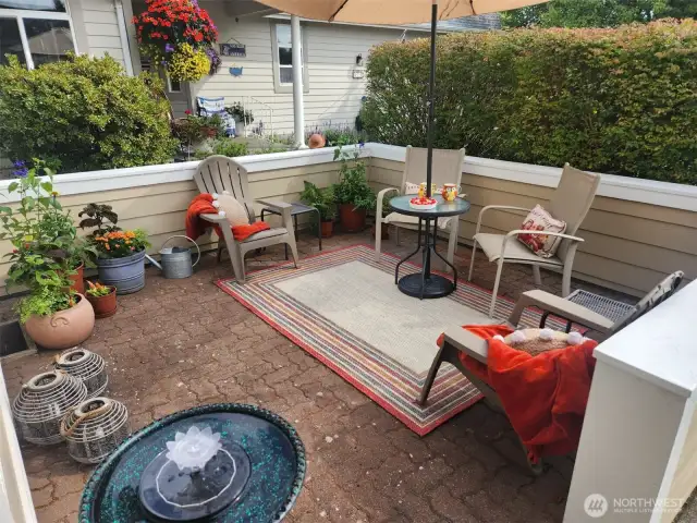 Hidden behind a row of bushes, this front courtyard offers a peaceful haven to relax or entertain.
