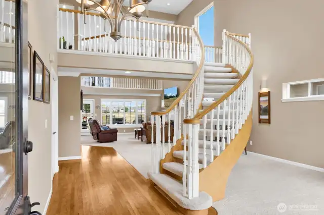 This gracious residence welcomes you with a spacious gathering room, where a dramatic curved staircase serves as a stunning architectural centerpiece.!