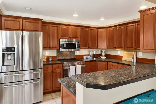 The inviting kitchen featuring stainless appliances.