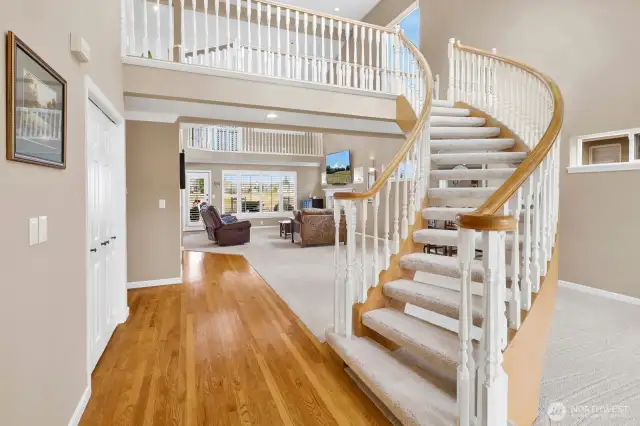A large closet to the left houses the coats, boots...and then, the showcase stairway leads you to the upper level of the home.