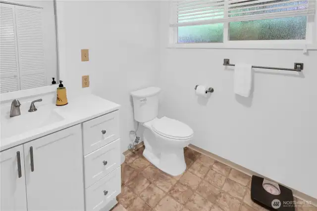 Lower level bathroom has a shower and utility room for washer and dryer hookups.