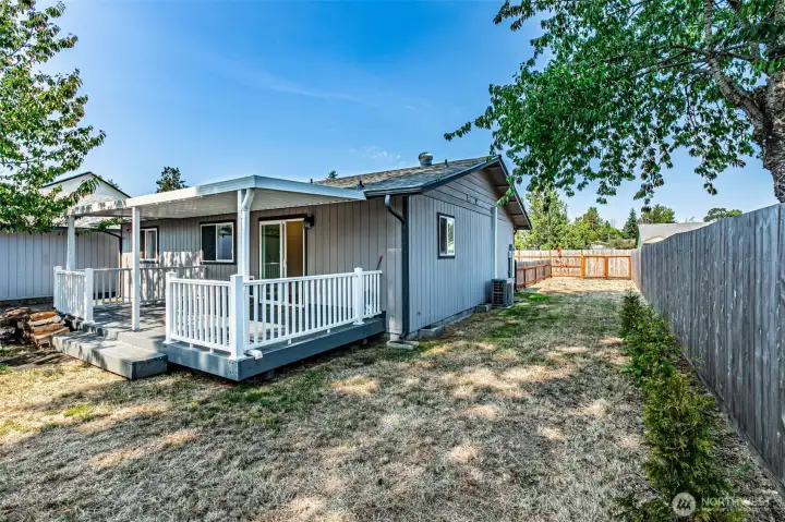Private rear yard with covered deck