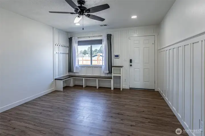 Built in bench with coat hooks above as you enter the home.  Vinyl plank flooring throughout the home.