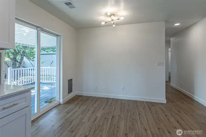 Dining area with sliders to the deck & built in dog door.