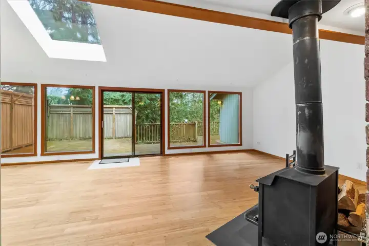 Walking into the Vaulted Great Room with ample light from skylights and wall of windows.