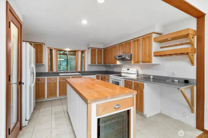 Kitchen with lighted pantry.
