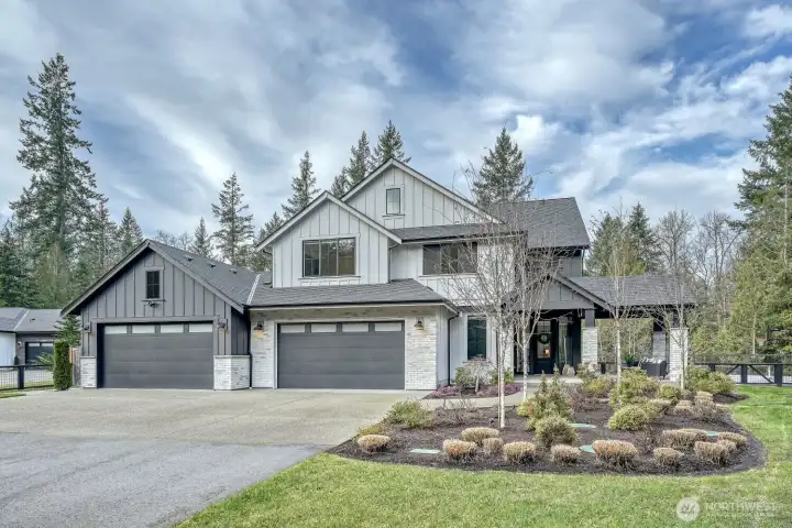 Front of home with beautiful landscaping along with programable landscaping lights throughout the property