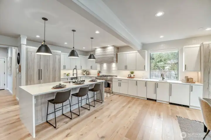 Bright and beautiful kitchen with massive island, counter top space and storage