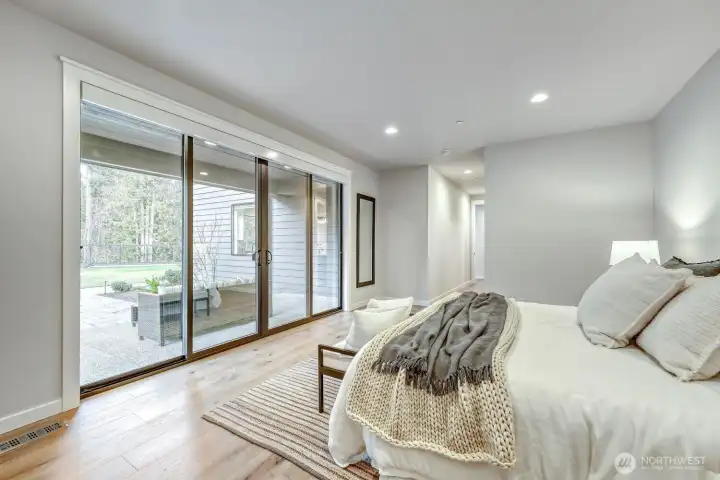 Main floor 2nd Primary with private patio set back from the rest of the backyard.