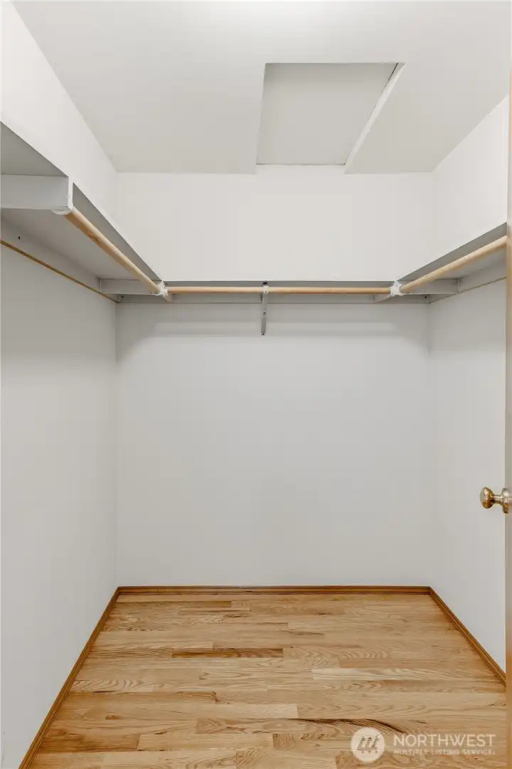 Generously sized primary walk-in closet. Hardwood floor, access to attic in the ceiling.