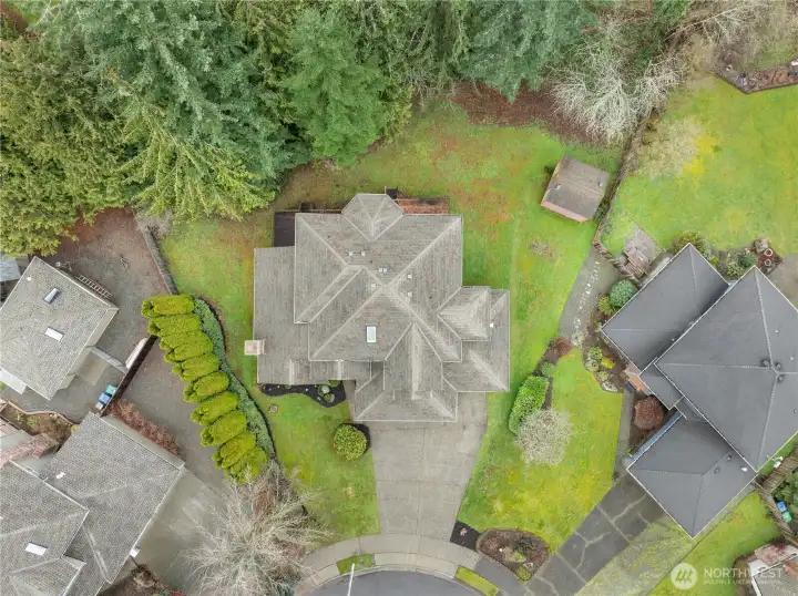 Aerial view showcasing the full lot, highlighting lush greenery and a private, serene setting. This home is in a neighborhood where residents stay for years.