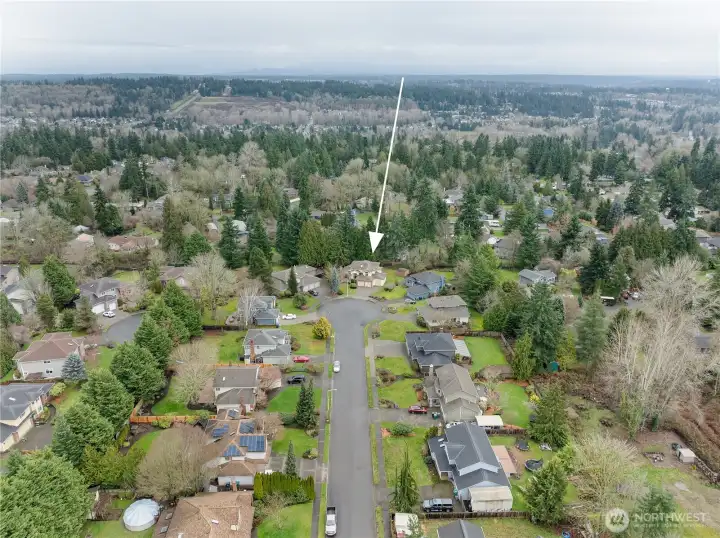 Aerial view looking east, with the home tucked at the end of the cul-de-sac for minimal traffic and maximum tranquility. This street is one where residents stay for years, creating a strong sense of community.