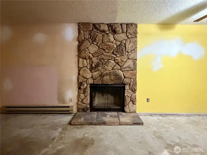 Cool statement fireplace would be beautiful with a honey-oak flooring and fresh paint.