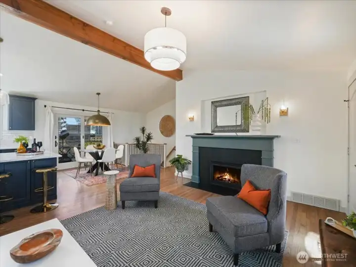 Cozy fireplace with a beautiful mantle, complemented by custom sconces on each side.