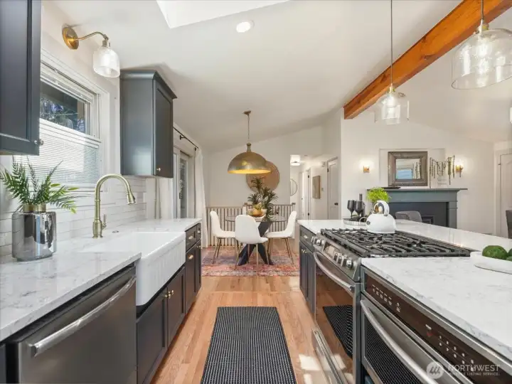 The kitchen remodel features new hardwood flooring designed to blend beautifully with the newly refinished living room floors.
