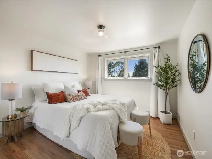 One of the three bedrooms on the main level has beautiful hardwood floors, wood wrapped windows allowing for an abundance of natural light.