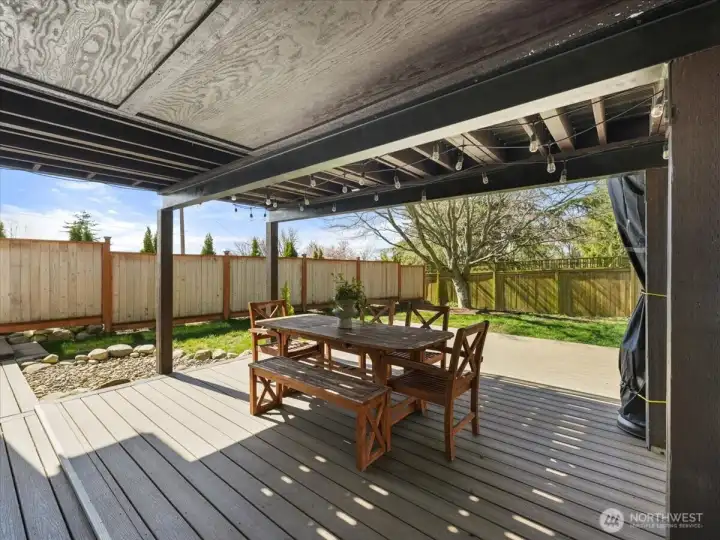 Enjoy year-round entertaining on the covered Trex deck and patio -designed for comfort and effortless outdoor living in every season.