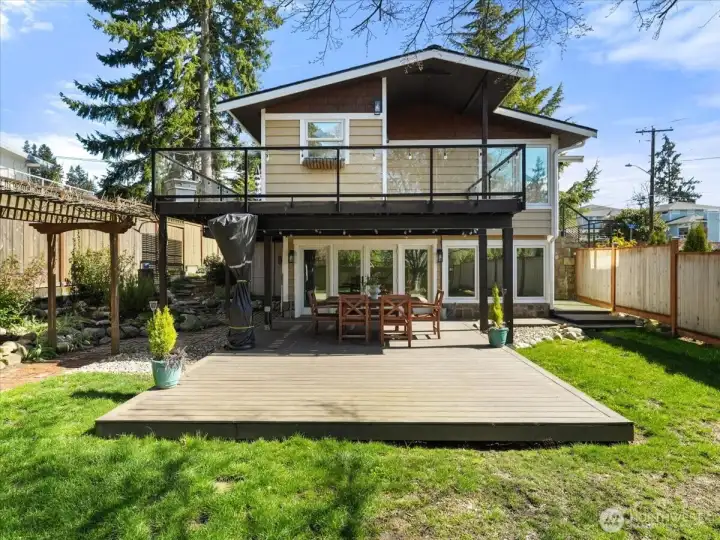 Two areas for outdoor entertaining. Upper wrap around Trex deck that can be accessed from kitchen and dining area. The western exposure views from the upper deck are stunning.  You won't want to miss the incredible Mt Rainier and sound views from this vantage point.  Lower level outdoor area can be accessed right off the downstairs bonus room.