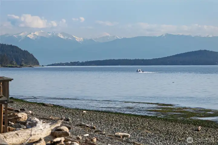 Olympic Mountain range peering over a boater headed into Fisherman Bay.