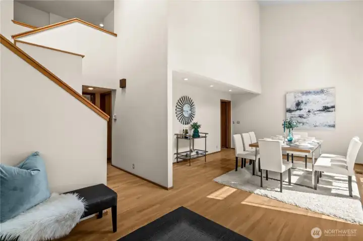 The foyer is flanked by impressive dining and living rooms.  A staircase accesses the upper floor bedrooms.