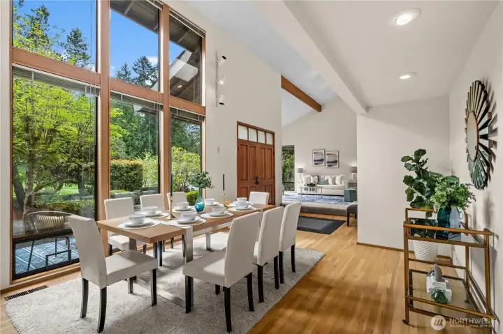 Floor to ceiling windows overlook the delightful lush green views of the front yard - like bringing the outdoors in .