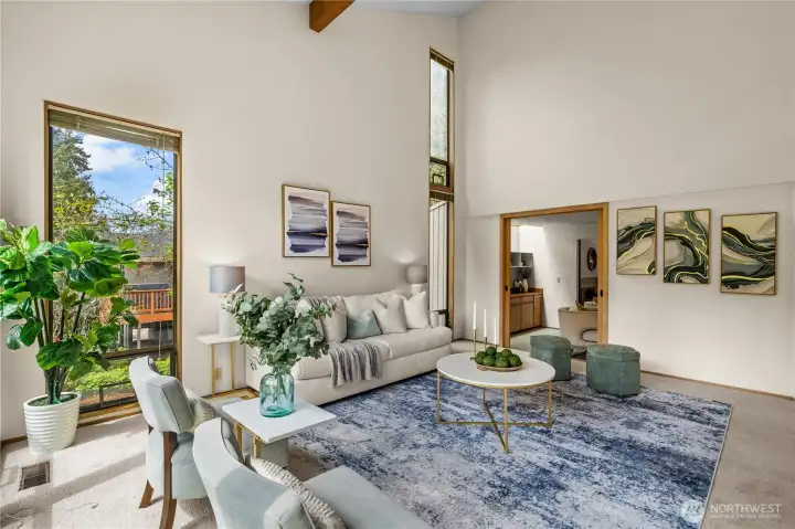 You'll fall in love with this inviting living room...it's light and bright, spacious and accommodating for your every need.   Furnish in traditional style or capture a mid-century vibe! In the background a den..or....