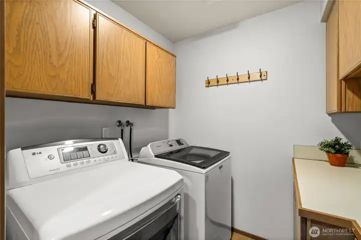 The Laundry Room is complete with a folding counter and storage cabinets, perfect for your household items.