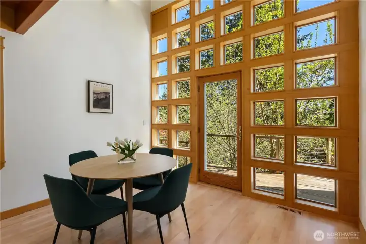 The dining area opens to a spacious south-facing deck for seamless indoor-outdoor living.