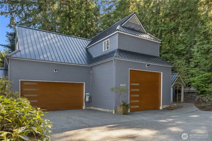 A covered breezeway connects to the detached oversized garage/shop.