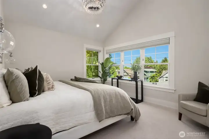 Large primary suite with vaulted ceilings, attached bath and walk-in closet