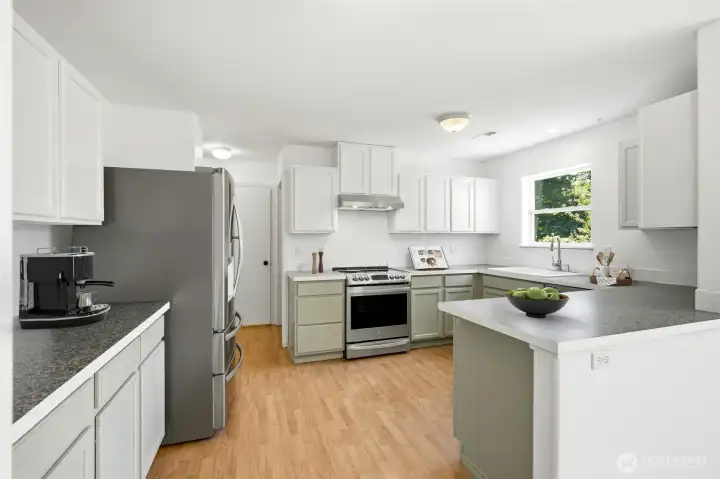 The beautifully updated kitchen blends modern convenience with timeless style. [Photo is virtually staged.]