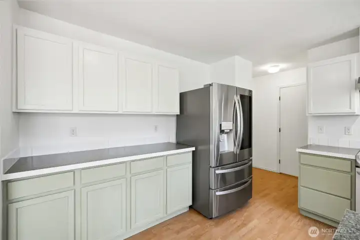 Custom-painted cabinetry creates a fresh, elevated look throughout the space.
