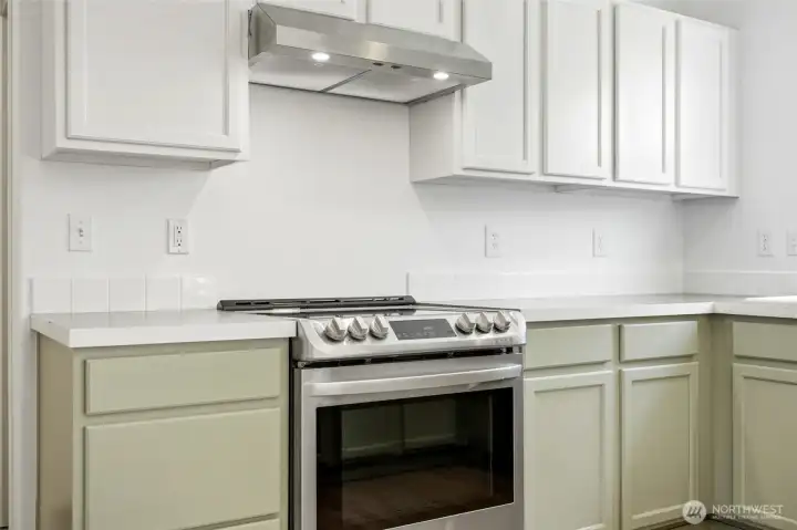 A sleek induction cooktop offers precision cooking while enhancing the clean, contemporary design.