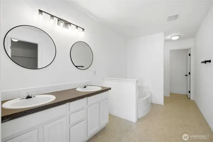 The luxurious five-piece ensuite creates a spa-like experience at home.  Dual vanities provide convenience for busy mornings.