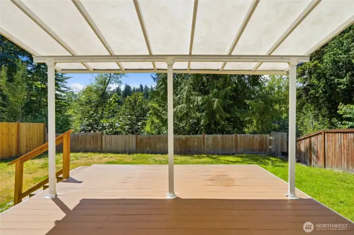 Step outside to a spacious covered deck designed for year-round enjoyment. Overlooking the protected greenbelt, the setting feels peaceful and private.