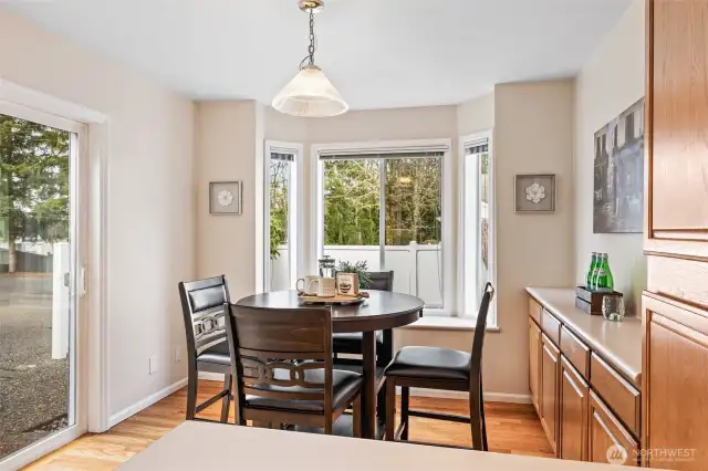 Bright breakfast nook with a sliding door leading to the garden patio.