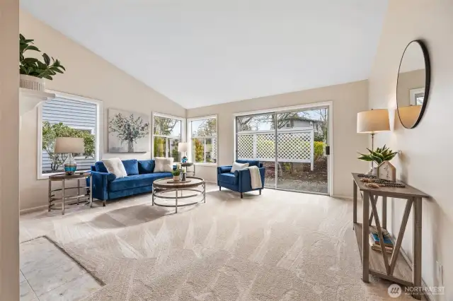 Living Room with vaulted ceiling and sliding door to the back patio