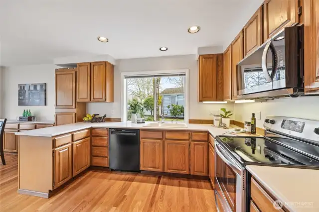 The kitchen features hardwood floors, a new microwave, a newer refrigerator, and more.