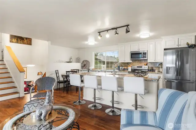 ~Open Concept Main Level Living Room view to oversized island and kitchen with granite counters throughout~